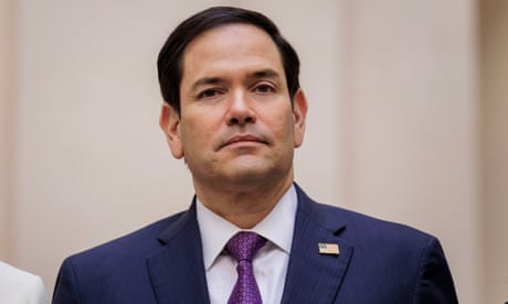 a man wearing a suit and tie looks at camera